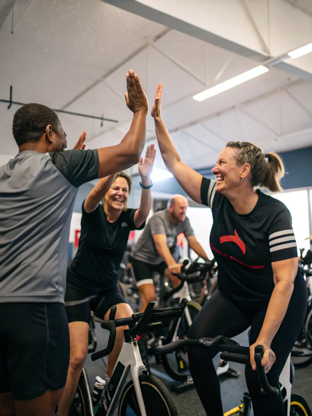 A photo of cyclists celebrating after completing a challenging ride, showcasing teamwork and achievement.